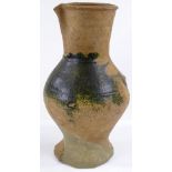 A Medieval terracotta jug with parts of original green glaze A/F, height 31cm