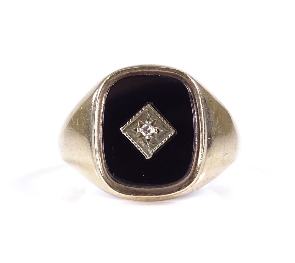 A 9ct gold onyx and diamond set signet ring, setting height 14.6mm, size S, 3.3g