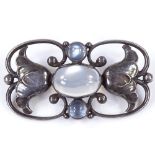 A Georg Jensen Danish sterling silver and moonstone brooch, with stylised pierced openwork floral