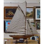 A Victorian wooden-hulled pond yacht, with original sails and rigging, hull length 92cm, overall