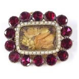 A Georgian flat-top garnet and seed pearl memorial brooch, with foil-backed stones and central