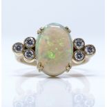 An unmarked gold white opal and diamond dress ring, setting height 12.7mm, size L, 3.2g