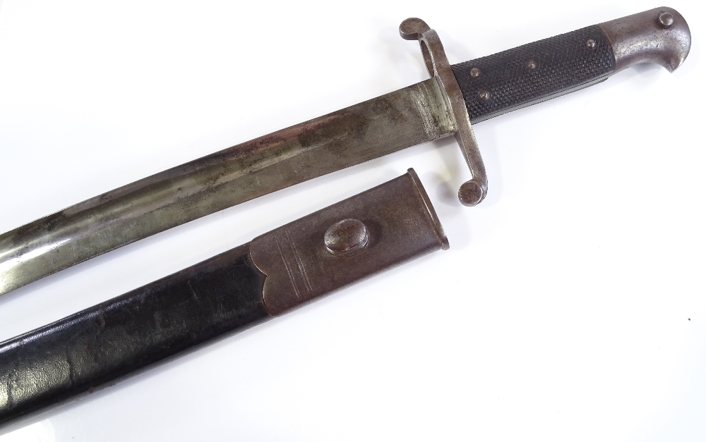 A late 19th century sword bayonet, overall length 71cm, original metal-mounted leather scabbard