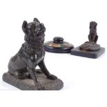 A 19th century cast-bronze sculpture of a seated dog, base length 11cm, and a carved green marble