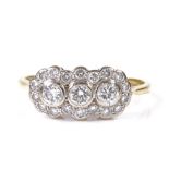 An 18ct gold diamond cluster dress ring, central diamond approx 0.1ct, setting height 7.8mm, size M,