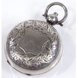 A circular silver sovereign case, with engraved floral decoration, maker's marks JW, hallmarks