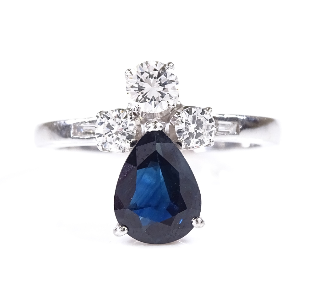 An 18ct white gold sapphire and diamond dress ring, with baguette-cut diamond shoulders, pear-cut