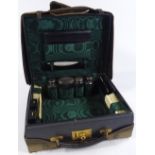 A leather-cased travelling set, with silver-topped jars and original canvas cover
