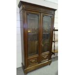 A walnut 2-door bookcase, circa 1900, with fluted columns and fielded panels, width 3'7", height 6'