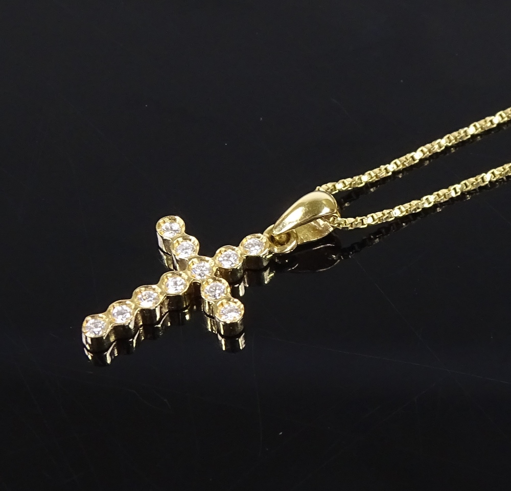 An 18ct gold diamond set cross pendant, on 18ct gold chain, pendant height 20.1mm, chain length