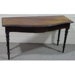An Edwardian mahogany serpentine front serving table, with carved frieze, raised on turned and