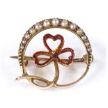 An Edwardian 15ct gold pearl and red enamel brooch, with graduated pearl set crescent and