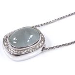 An 18ct white gold moonstone and diamond cluster pendant necklace, on 18ct chain, pendant height