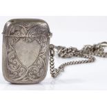 A curved engraved silver Vesta case, on a graduated curb link chain with T-bar, overall chain length