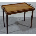 A Victorian mahogany butler's tray on folding legs