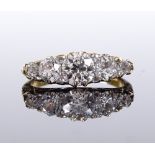 An 18ct gold 5-stone graduated diamond dress ring, with pierced scrollwork bridge and diamond chip