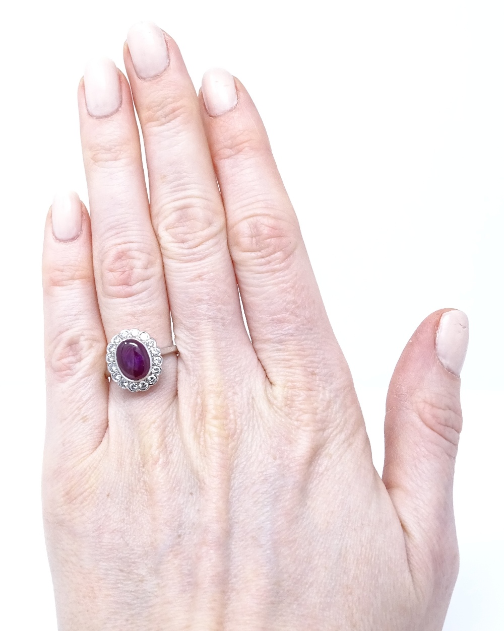 An 18ct white gold cabochon ruby and diamond cluster ring, ruby dimensions 9.6mm x 7.36mm x 3. - Image 4 of 4