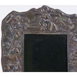 An embossed silver-fronted photo frame, with cherub decoration, by Ray Hall, hallmarks Birmingham