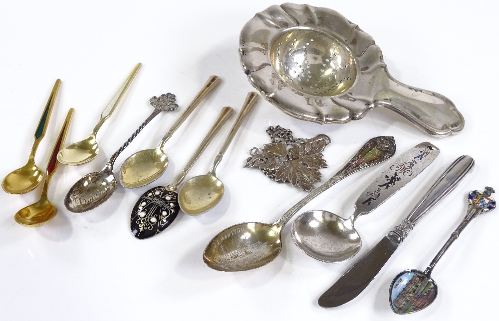 Silver and enamel teaspoons, a silver tea strainer etc