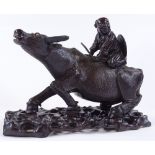 A Chinese carved and stained hardwood figure riding a buffalo, on original carved and pierced wood