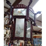 A Chinese carved wood lantern light shade, with reverse painted glass panels