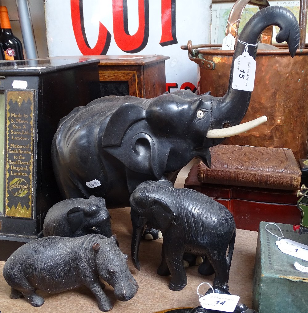 A large African carved ebony elephant, length 13", and 3 smaller elephant and hippo (4)