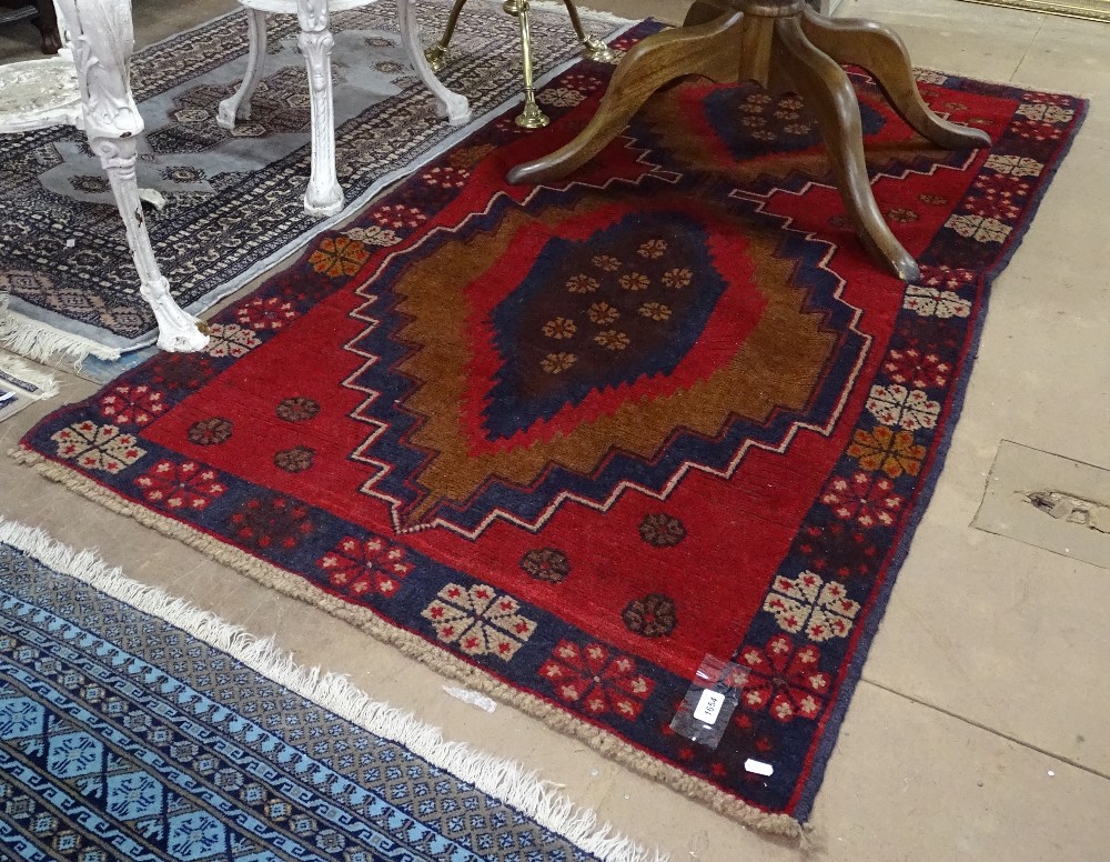 A red ground Beluchi rug, 190cm x 103cm