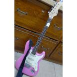 A Rockburn pink electric guitar