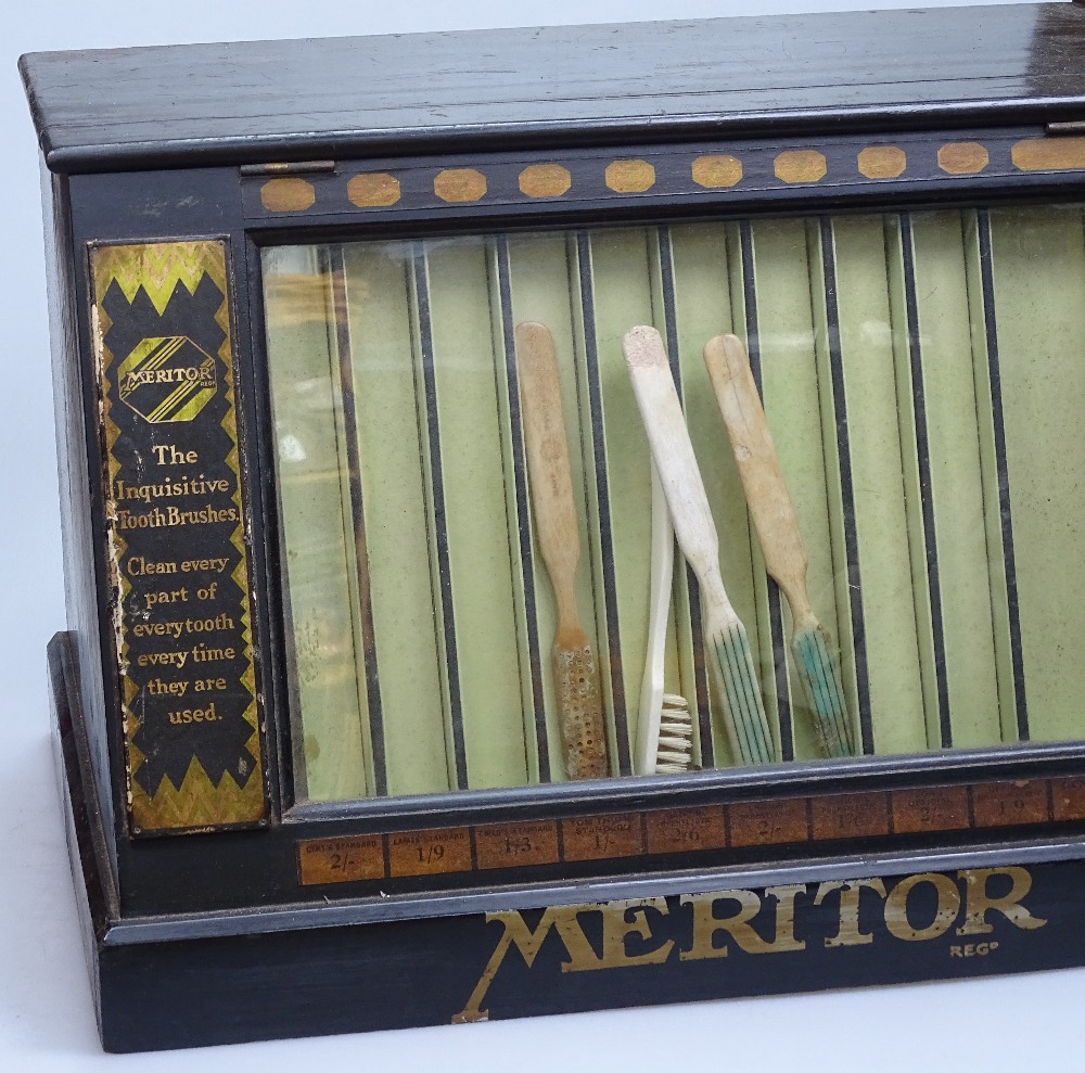 A Vintage Meritor shop counter toothbrush display case, with glazed front and drawer fitted back,