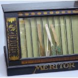 A Vintage Meritor shop counter toothbrush display case, with glazed front and drawer fitted back,