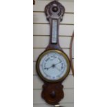 A carved oak-framed aneroid barometer with thermometer, 32"