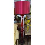 An unusual ruby red glass standard lamp, on circular chrome base, with matching shade, height