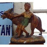 A painted plaster figure of a boy with an Alsatian, height 15.5"