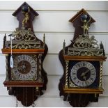 A pair of mahogany and brass wall clocks with chains