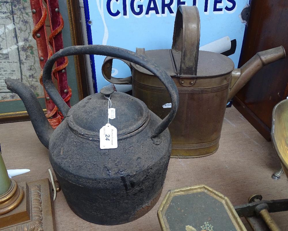A large Victorian brass water can, and cast-iron teapot