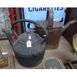 A large Victorian brass water can, and cast-iron teapot