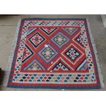 A multi-coloured Kilim rug, 95cm x 104cm