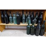 A shelf of aqua, beer and brewery bottles