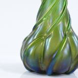 A Loetz green iridescent glass narrow-necked bottle vase of twist design, height 25cm