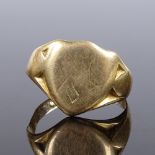 An 18ct gold shield-shaped signet ring, maker's marks JH, panel height 13.2mm, size O, 4.8g (shank