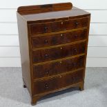 A good quality Edwardian strung mahogany bow-front chest of 5 long drawers, with turned ebony