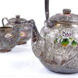 An Oriental silver 3-piece tea set, with all over relief embossed floral decoration, and applied