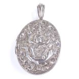 An unmarked Indian silver oval photo locket pendant, depicting incarnation of Ganesha riding a