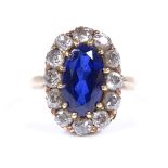 An unmarked gold large sapphire and diamond cluster ring, sapphire measures 11.5mm x 6.74mm x 4.2mm,