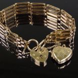 A 9ct gold heart lock gate link charm bracelet, together with a 9ct heart pendant, 19.5g total