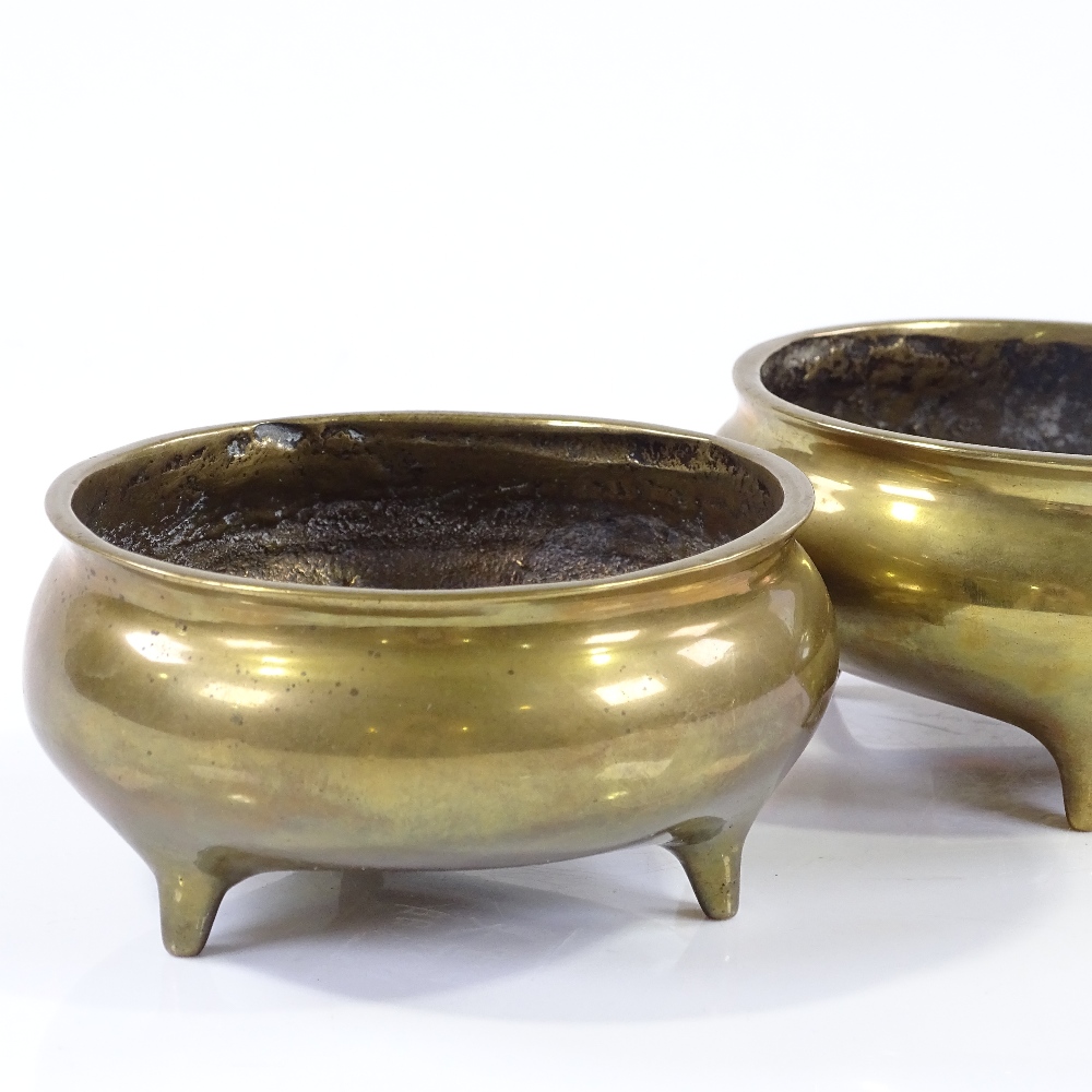 A pair of Chinese bronze incense burners on 3 feet, diameter 11cm