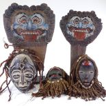 A group of modern African Tribal carved wood masks and two Javanese theatre masks.