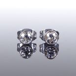 A pair of unmarked gold solitaire diamond ear studs, diameter 4.4mm