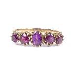 An unmarked gold 5-stone amethyst ring, setting height 6.7mm, size T, 3g