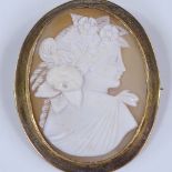 A relief carved cameo brooch, depicting female Classical portrait with floral wreath, in 9ct gold